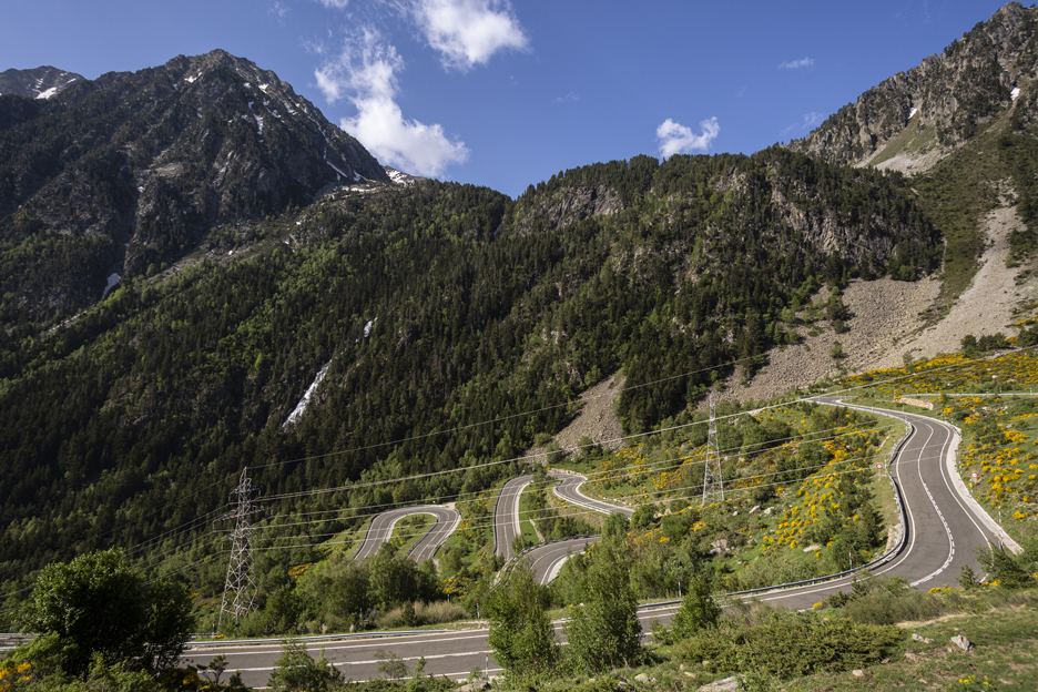 Windy roads snaking up the green valley of the Pyrenees in Europe