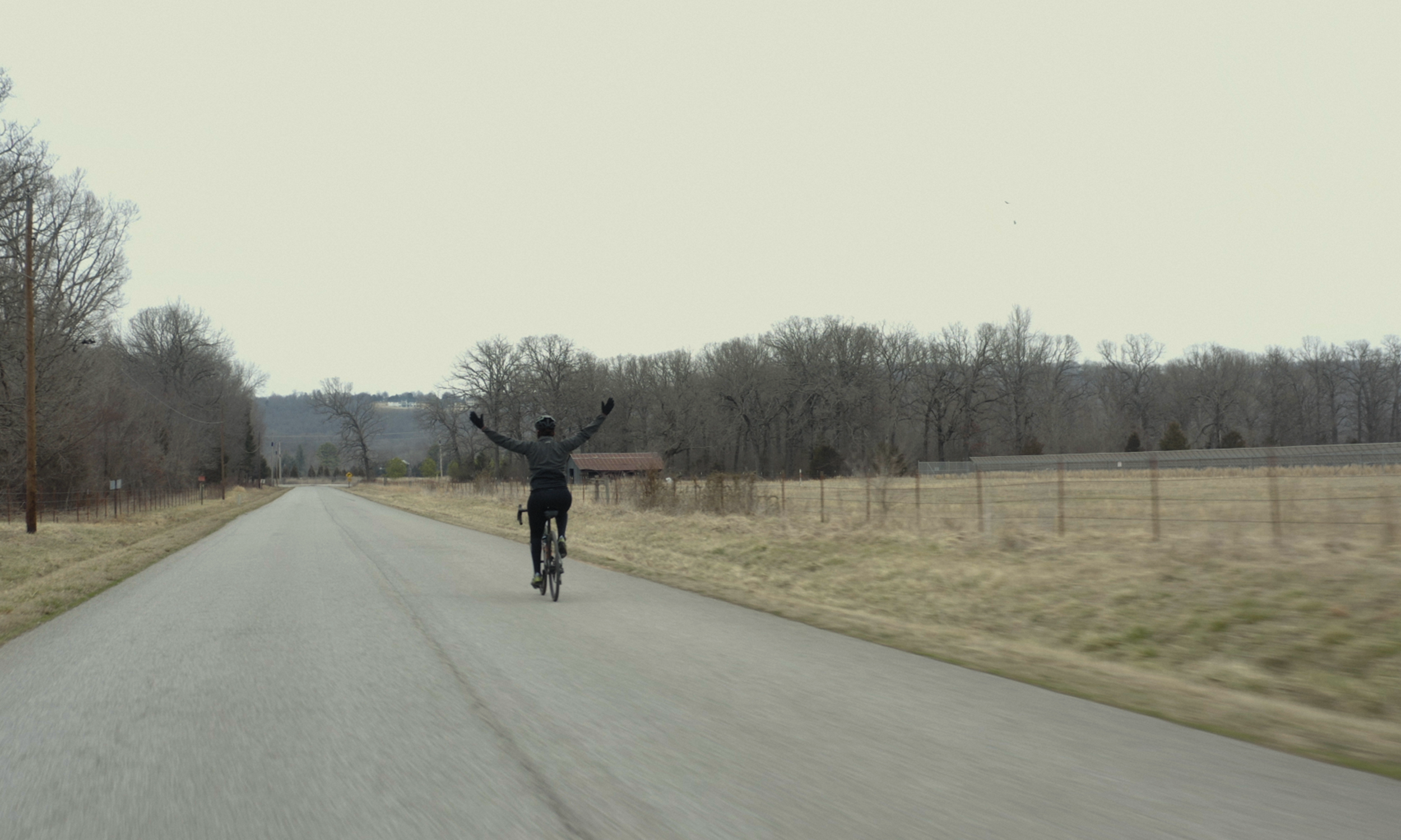 KC Cross riding down he road in Beyond the Binary